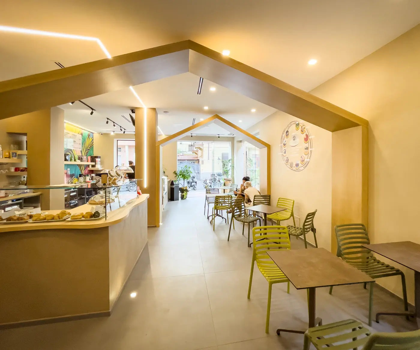 The CoffeeStorming dining room, with its pitched ceiling and green chairs.